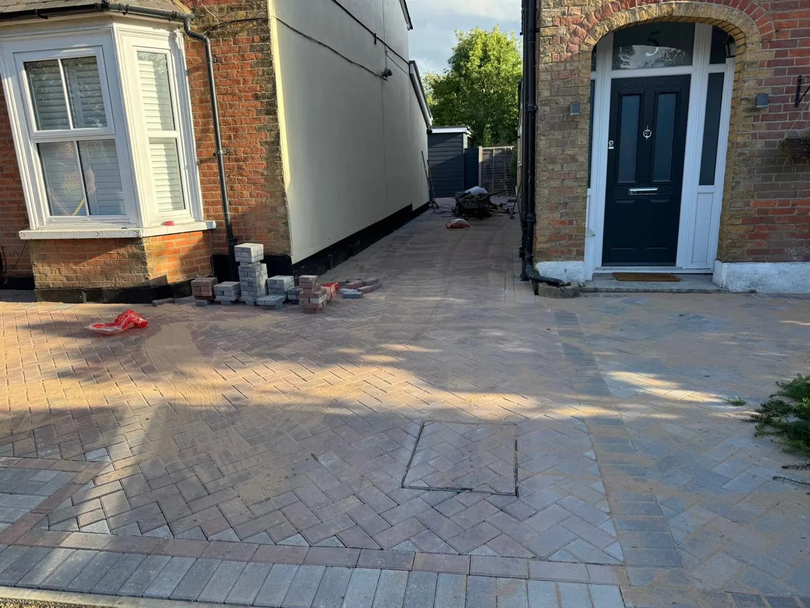 Finished brindle block paved path down the side return