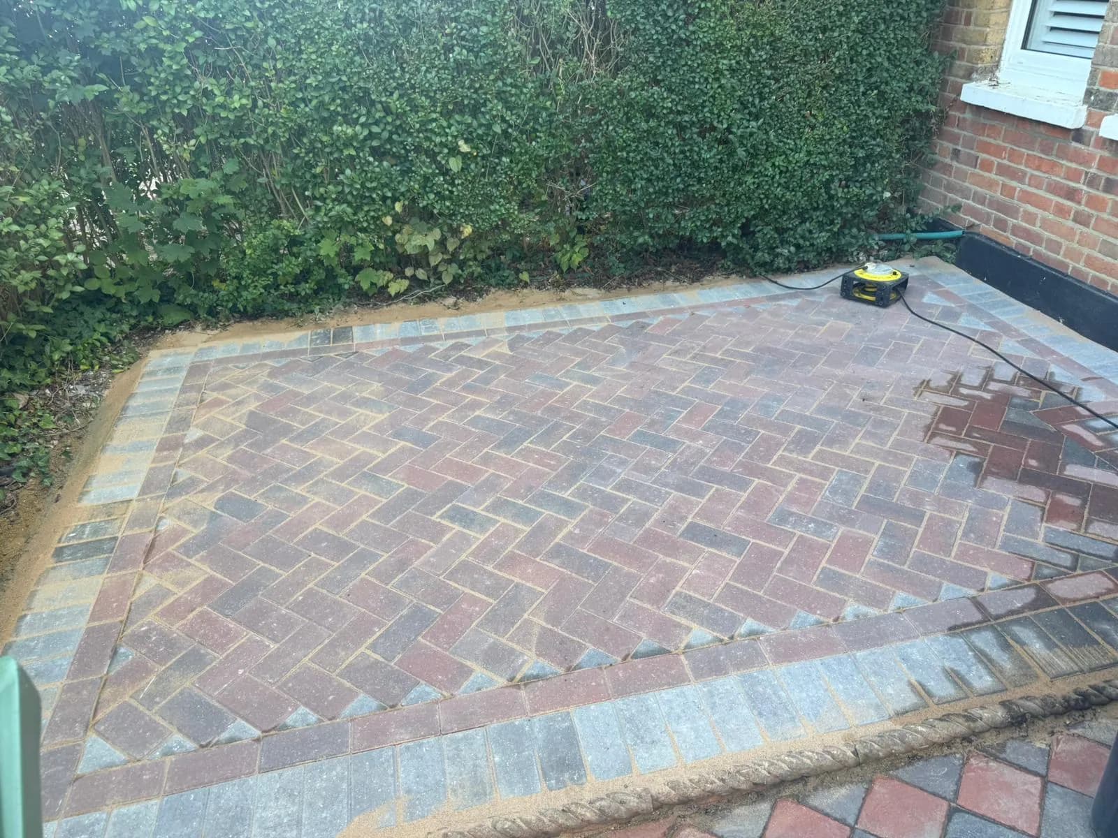 Finished brindle block paving in the rear courtyard between period houses