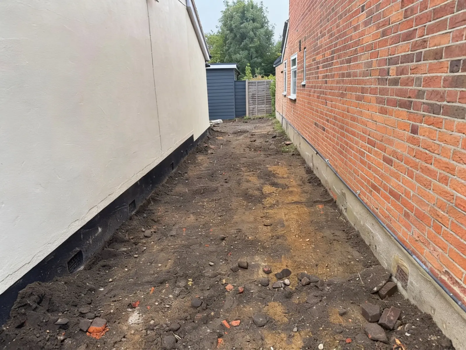Side access stripped back to sub-grade before paving