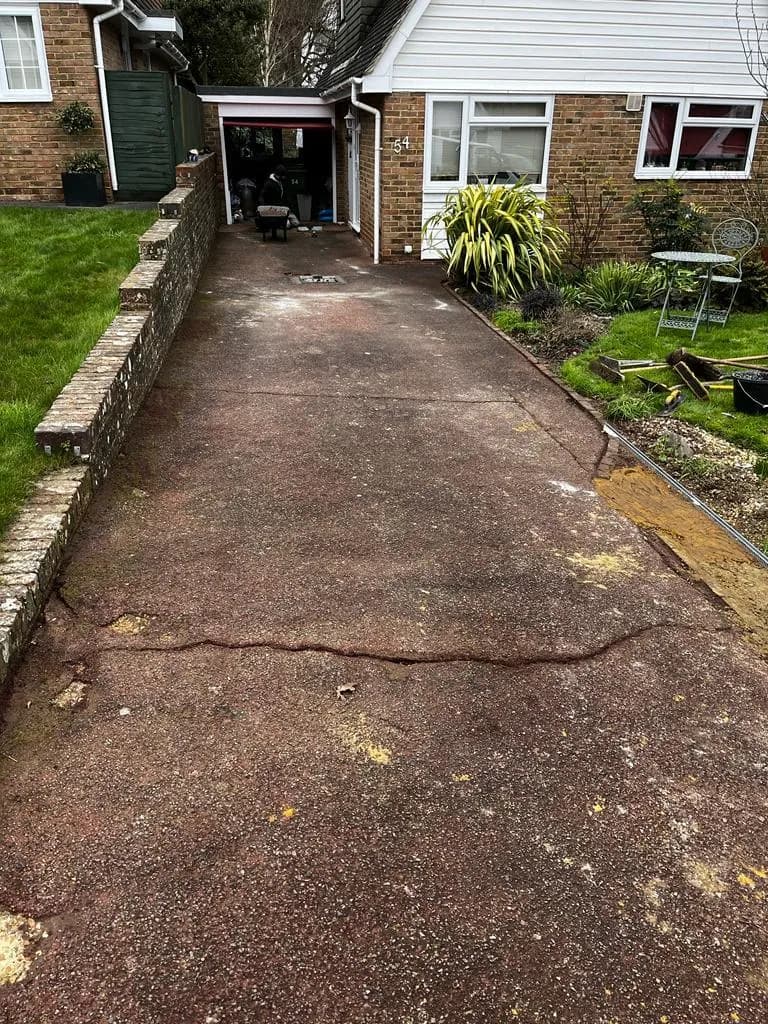 Worn, stained driveway before resurfacing
