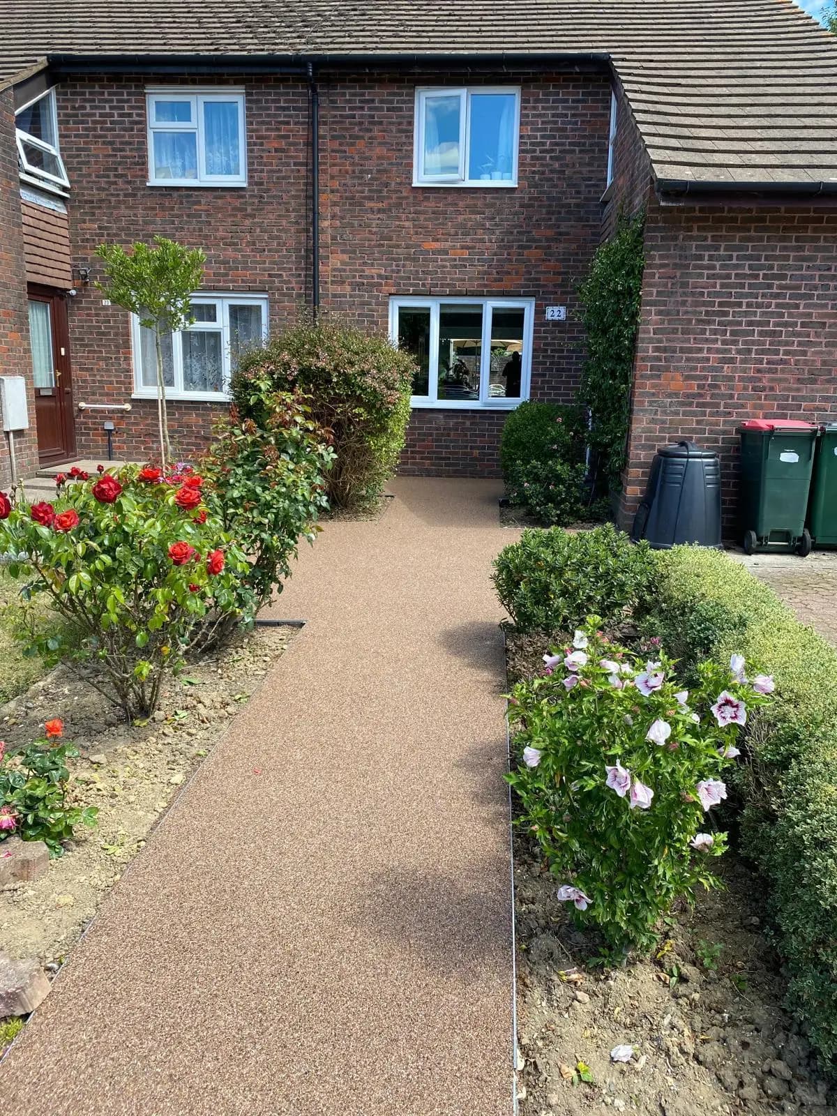 Finished gold resin-bound front path between planted borders in Crawley