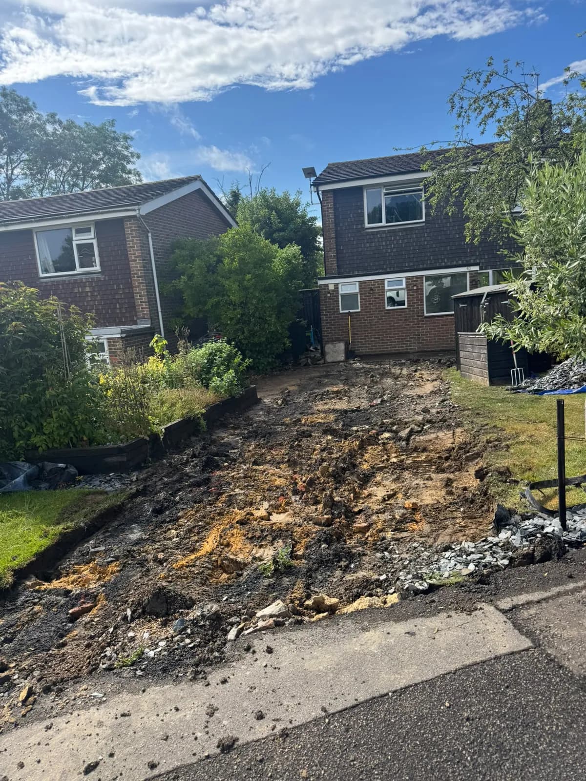The broken-up old driveway before the works