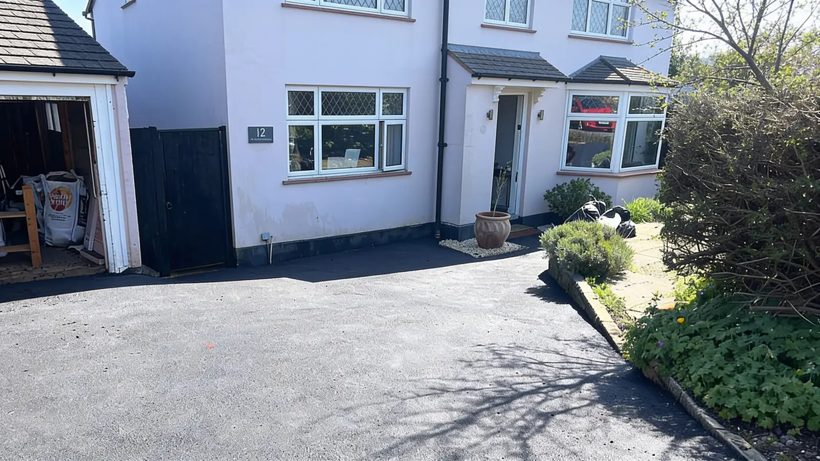 Finished smooth tarmac driveway in front of a white house in Virginia Water